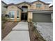 Inviting two-story home with a double-door entryway and attached two-car garage, set against a neatly landscaped front yard at 3237 Perching Bird Ln, North Las Vegas, NV 89084