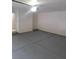Clean, empty two-car garage with a gray epoxy floor and white walls, ready for customization and organization at 3237 Perching Bird Ln, North Las Vegas, NV 89084