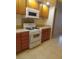 Kitchen with gas range, microwave, wood cabinets, and tile countertops at 3237 Perching Bird Ln, North Las Vegas, NV 89084