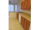 Kitchen featuring wood cabinets, tile countertops, and stainless steel sink at 3237 Perching Bird Ln, North Las Vegas, NV 89084