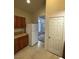 Kitchen with a modern refrigerator and wood cabinets with tiled countertops at 3237 Perching Bird Ln, North Las Vegas, NV 89084
