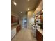 Spacious kitchen featuring modern appliances, wooden cabinets, and tile flooring at 3237 Perching Bird Ln, North Las Vegas, NV 89084