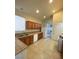 Functional kitchen featuring wooden cabinets, tile countertops, and appliances; refrigerator included at 3237 Perching Bird Ln, North Las Vegas, NV 89084