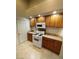 Charming kitchen featuring wooden cabinets, tile countertops, and modern appliances at 3237 Perching Bird Ln, North Las Vegas, NV 89084