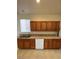 Kitchen with wood cabinets, tile countertops, and a stainless steel sink at 3237 Perching Bird Ln, North Las Vegas, NV 89084