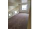 Loft with worn gray carpet and a window at 3237 Perching Bird Ln, North Las Vegas, NV 89084