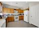 Functional kitchen featuring light cabinets and white appliances at 3359 Commendation Dr, Las Vegas, NV 89117