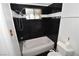 Bathroom featuring black tiled walls and a tub with shower at 3633 Monte Verde St, Las Vegas, NV 89121
