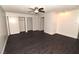 Spacious bedroom featuring dark wood flooring, ceiling fan, and ample closet space at 3633 Monte Verde St, Las Vegas, NV 89121
