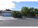 Charming single-story home with a well-manicured front yard, mature trees, and a two-car garage at 3633 Monte Verde St, Las Vegas, NV 89121