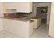 Functional kitchen with granite countertops, tiled floors, white cabinetry, and a center island at 3633 Monte Verde St, Las Vegas, NV 89121