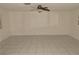 Spacious living room featuring tile flooring and a ceiling fan for added comfort at 3633 Monte Verde St, Las Vegas, NV 89121