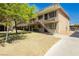 Apartment building featuring a stucco exterior, stair access, and landscaping at 3719 Hazelwood St # 16, Las Vegas, NV 89119