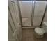 Bathroom showcasing a glass-enclosed shower and a toilet at 3755 Chutney St, Las Vegas, NV 89121