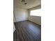 This bedroom features a closet with sliding doors, wood-look floors and a window at 3755 Chutney St, Las Vegas, NV 89121