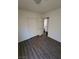 This bedroom features a closet with sliding doors, wood-look floors and a door to another room at 3755 Chutney St, Las Vegas, NV 89121