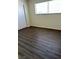 This bedroom has modern laminate flooring, a large window and closet at 3755 Chutney St, Las Vegas, NV 89121