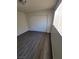 This bedroom features a closet with sliding doors, wood-look floors and a window at 3755 Chutney St, Las Vegas, NV 89121