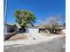 Single-story home with a detached garage, curb appeal and desert landscaping at 3755 Chutney St, Las Vegas, NV 89121
