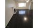 Living room with dark wood laminate flooring, fireplace, and large window at 3755 Chutney St, Las Vegas, NV 89121