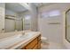 A full bathroom with a sink, toilet, shower, and blue wallpaper at 399 Discovery Ct, Henderson, NV 89014