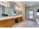 Well-lit bathroom boasts a double vanity, large mirror, and tub at 399 Discovery Ct, Henderson, NV 89014