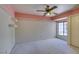 Bright bedroom features a ceiling fan and a window with natural light at 399 Discovery Ct, Henderson, NV 89014
