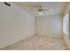 Clean and well-lit bedroom featuring tile flooring, a ceiling fan, and shuttered windows at 399 Discovery Ct, Henderson, NV 89014