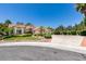 Well-maintained single-story residence featuring a manicured lawn, mature trees, and a large driveway at 399 Discovery Ct, Henderson, NV 89014
