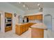 Modern kitchen with stainless steel appliances, island cooktop, and tile countertops at 399 Discovery Ct, Henderson, NV 89014