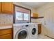 Laundry room featuring front load washer and dryer, window, and storage at 399 Discovery Ct, Henderson, NV 89014