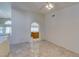 Bright living area with tile flooring, white walls, and an arched doorway leading to the kitchen at 399 Discovery Ct, Henderson, NV 89014