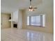 Spacious living room featuring tile floors, a fireplace, and is open to the dining area at 399 Discovery Ct, Henderson, NV 89014