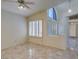 Inviting living room with tile floors, neutral walls, and a partial view of the front entrance and hallway at 399 Discovery Ct, Henderson, NV 89014