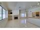 Spacious living room featuring tile floors, a fireplace, and is open to the kitchen area at 399 Discovery Ct, Henderson, NV 89014