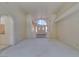 Bright living room with carpet and an arched entryway to the kitchen at 399 Discovery Ct, Henderson, NV 89014