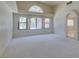 Bright living room showcasing vaulted ceilings, new carpet, large windows, and arched entryway at 399 Discovery Ct, Henderson, NV 89014