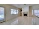 Open-concept living room with tile floors, fireplace, and bright window at 399 Discovery Ct, Henderson, NV 89014