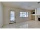 Bright living room featuring tile floors, a fireplace, and a large window bringing in natural light at 399 Discovery Ct, Henderson, NV 89014
