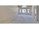 Spacious living room with vaulted ceilings, carpet, and bright windows at 399 Discovery Ct, Henderson, NV 89014