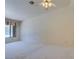 Open living room with neutral carpet, fan and a bright window at 399 Discovery Ct, Henderson, NV 89014