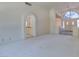 Living room with carpet and an arched entryway to the kitchen at 399 Discovery Ct, Henderson, NV 89014