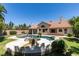 Inviting backyard with a rock-accented pool, covered patio, and lush greenery surrounding the property at 399 Discovery Ct, Henderson, NV 89014