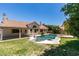 Backyard oasis features a custom pool, covered patio, and a well-maintained lawn at 399 Discovery Ct, Henderson, NV 89014