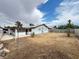 Wide view of the backyard with a covered patio attached to the house, and a partial fence enclosure at 4303 Paramount St, Las Vegas, NV 89115