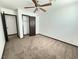 Neutral bedroom with a ceiling fan, carpet flooring, and closet at 4303 Paramount St, Las Vegas, NV 89115