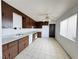 The kitchen offers wood cabinets, white appliances, and tiled floors at 4303 Paramount St, Las Vegas, NV 89115