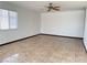 Spacious living room features tile floors, a ceiling fan, and neutral paint at 4303 Paramount St, Las Vegas, NV 89115