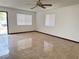 Bright living room with tile floors, ceiling fan, and natural light at 4303 Paramount St, Las Vegas, NV 89115