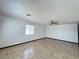 Bright living room features tile floors, a ceiling fan, and natural light at 4303 Paramount St, Las Vegas, NV 89115
